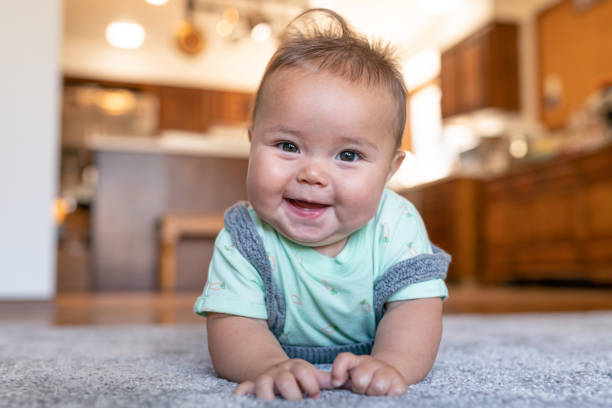 Baby lying on carpet flooring | Kopp's Carpet & Decorating