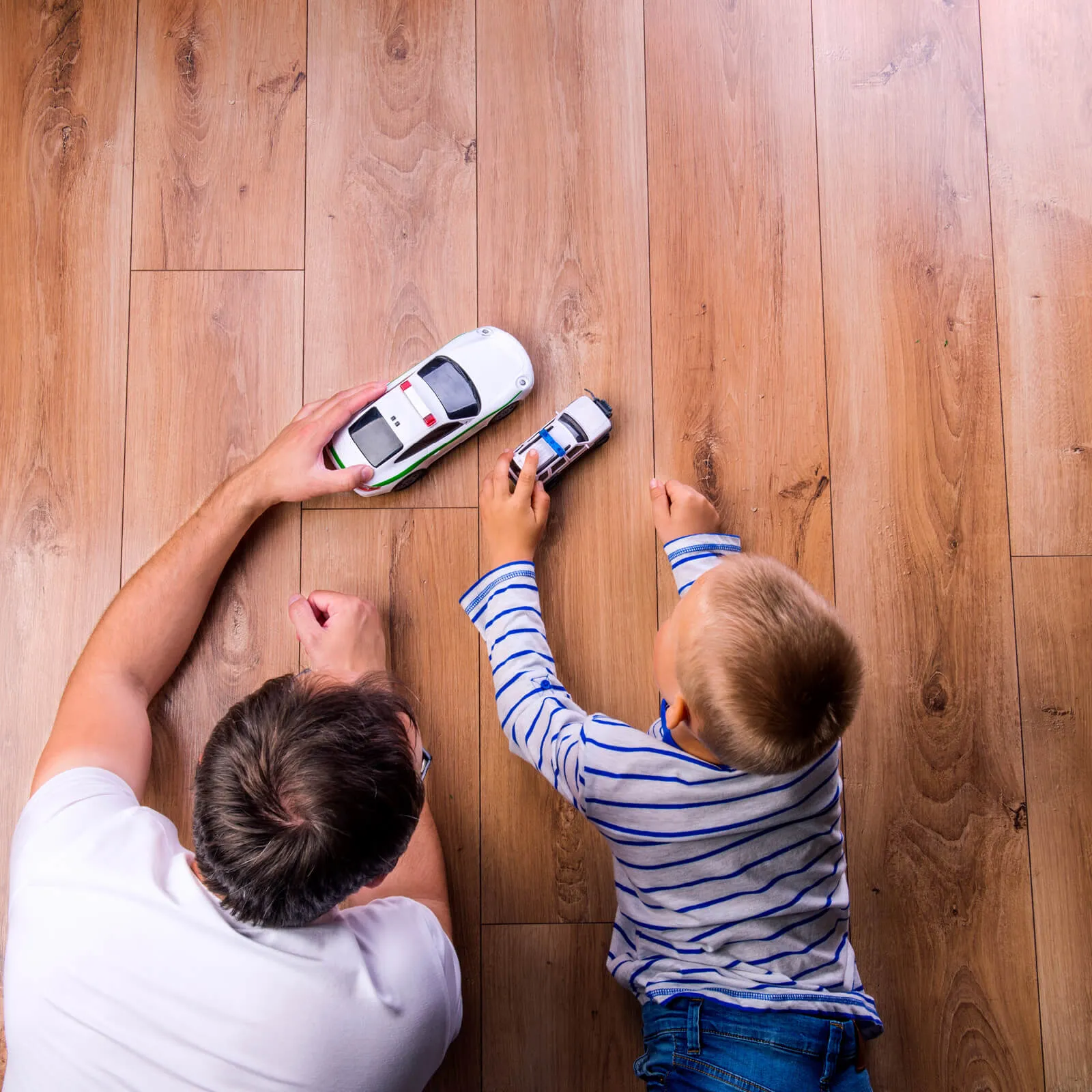 dad Child playing on Hardwood | Kopp's Carpet & Decorating